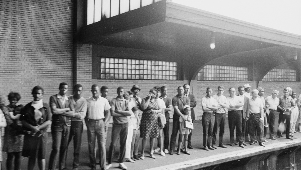 People wait on a train platform to pay respects as the Robert Kennedy Funeral Train passes by.