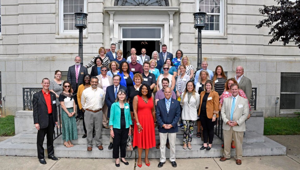 Delaware County Community College President Dr. L. Joy Gates Black, center, is surrounded by invited guests on the steps of the former Archbishop Prendergast High School.