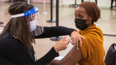 woman getting COVID-19 vaccine