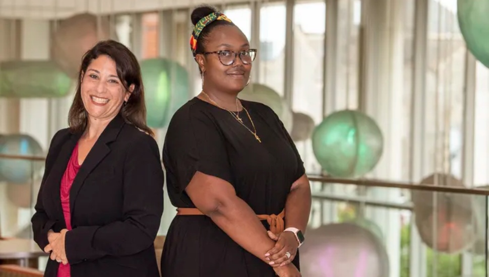 two women helping pregnant women