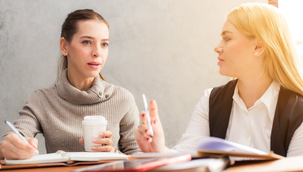 Two young professional women at work.