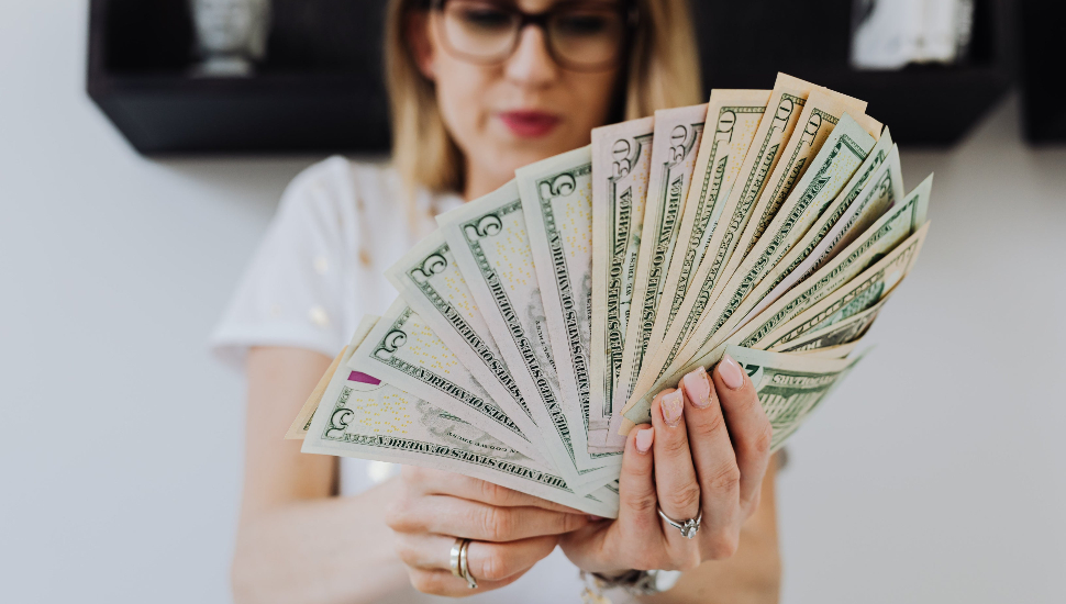 Young Woman holding American paper currency