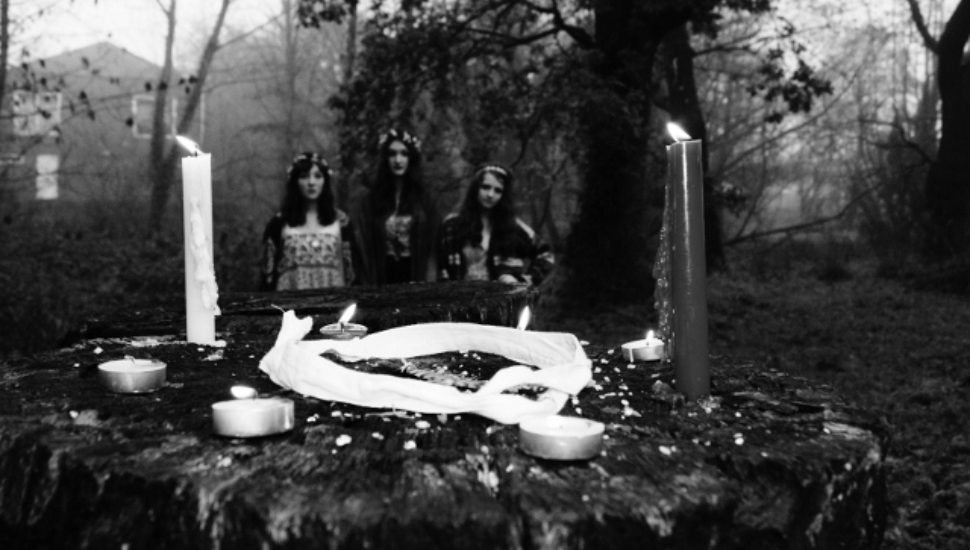 women standing by a gravesite