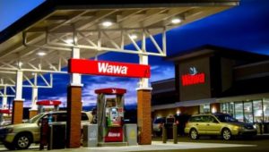 The outside of a Wawa store and gas pumps.