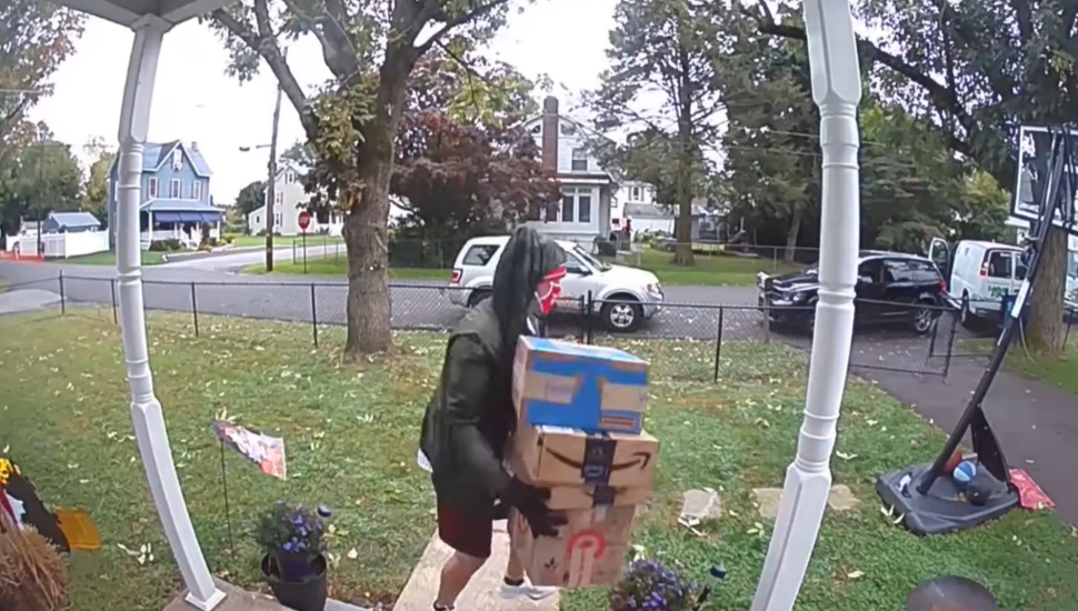 man on porch with packages