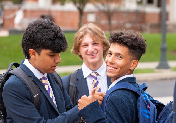 school students offering a thumbs up.