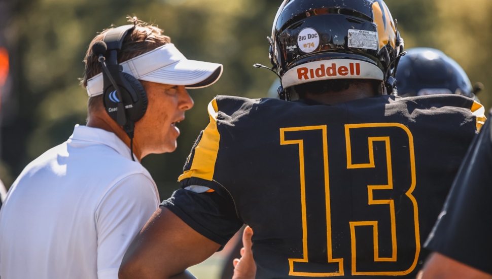 football coach with player