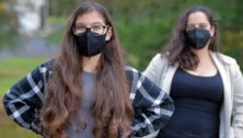 two women wearing masks