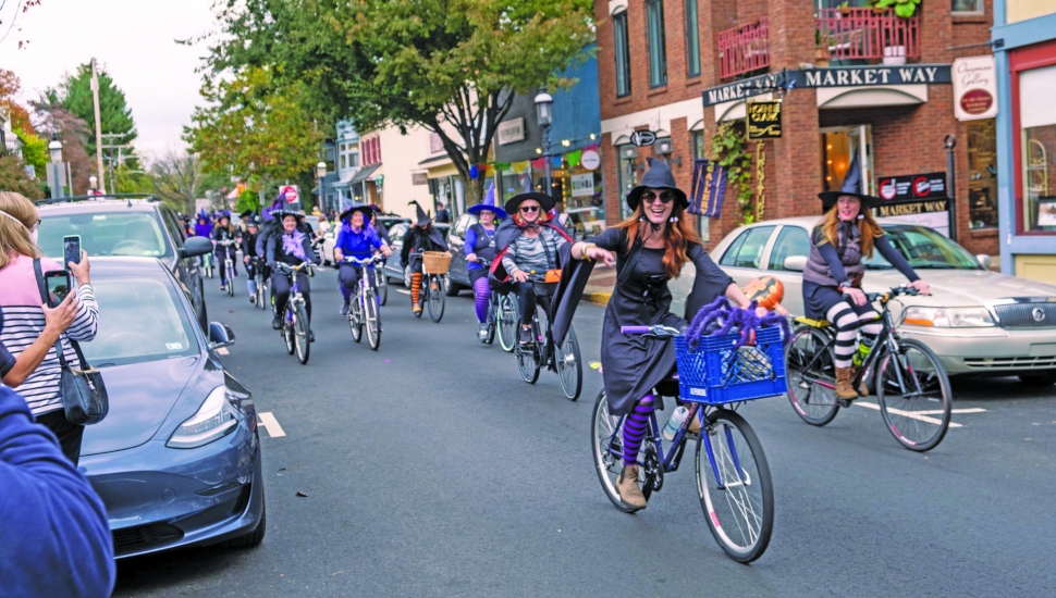 women in witch costumes on bikes