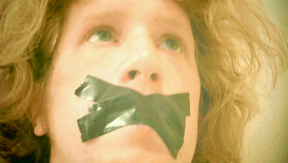 man with taped mouth