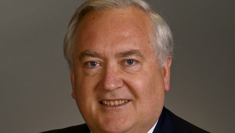 gray-haired man against gray background