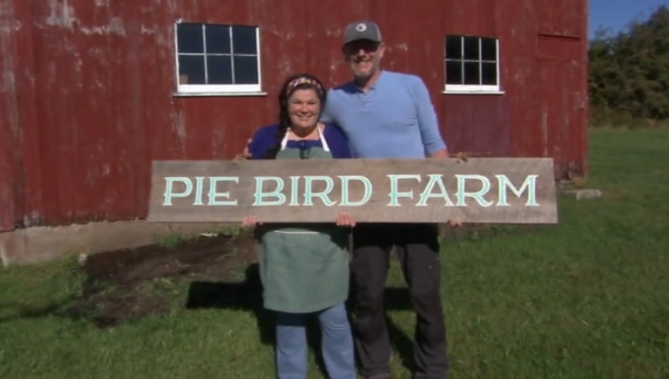 woman and man holding a sign