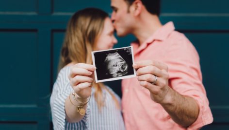 woman and man with ultrasound photo
