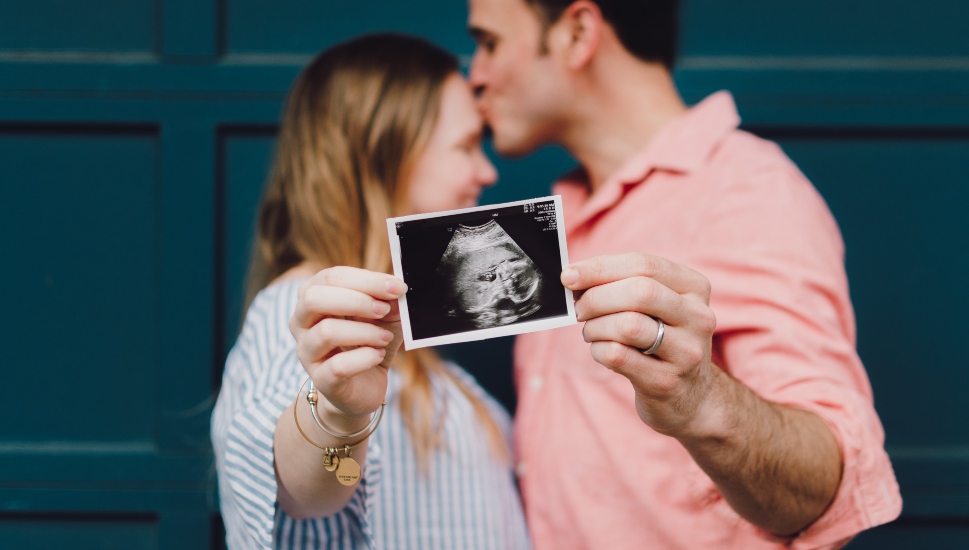 woman and man with ultrasound photo