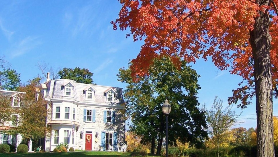 big house with red tree