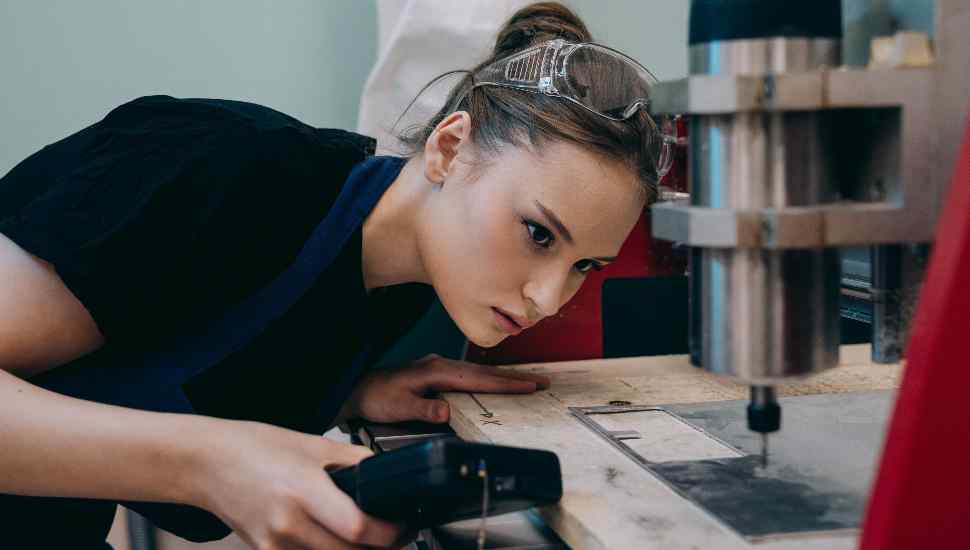 female with drill press