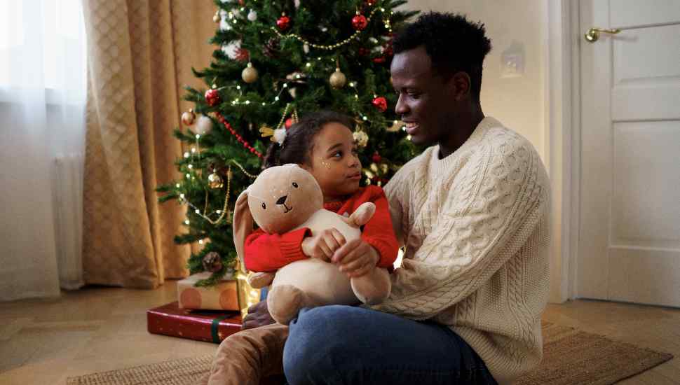 man with child and tree