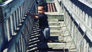 boy on wooden steps