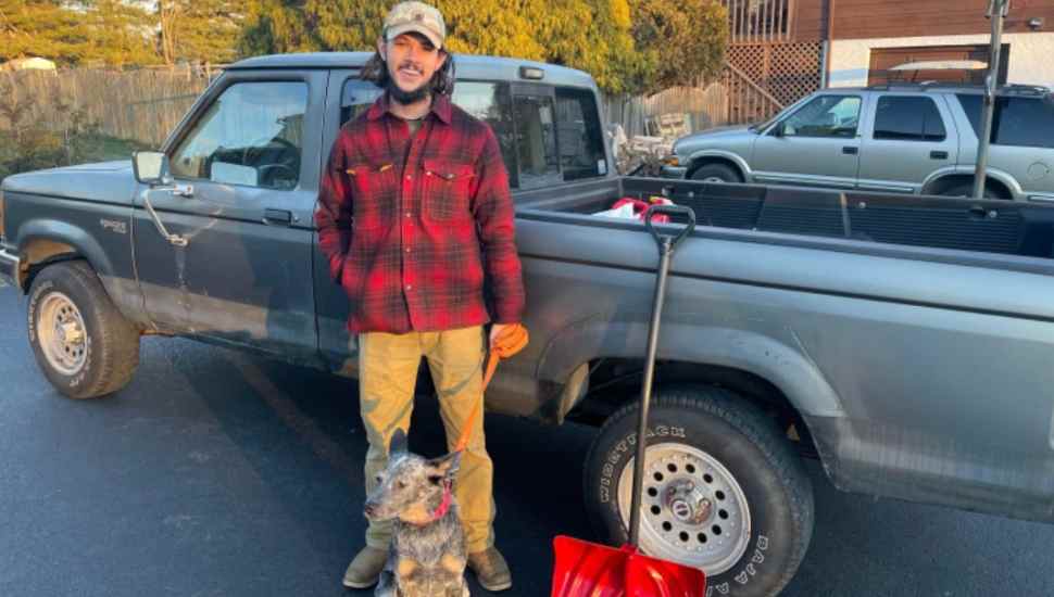 man and dog with truck
