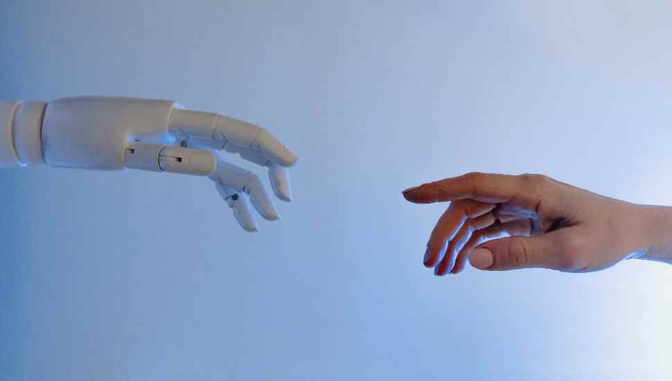 one real hand, one robot hand