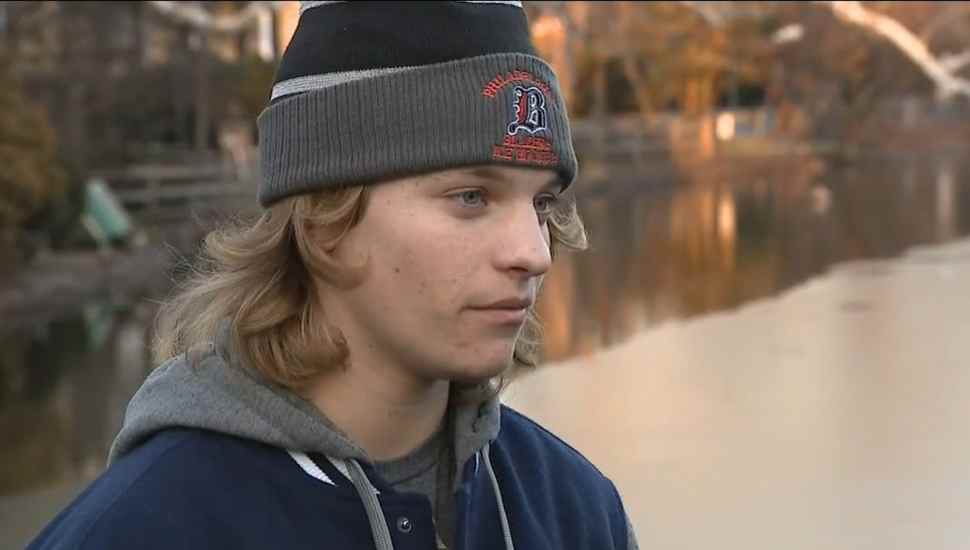 teenager in a hat at a frozen lake
