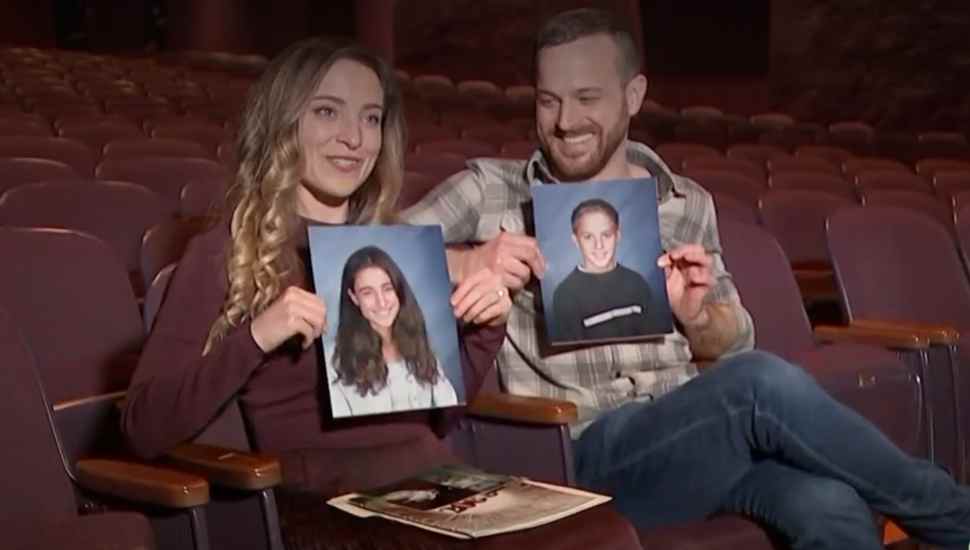 Christy Altomare and Chris Crook, holding their school portraits.