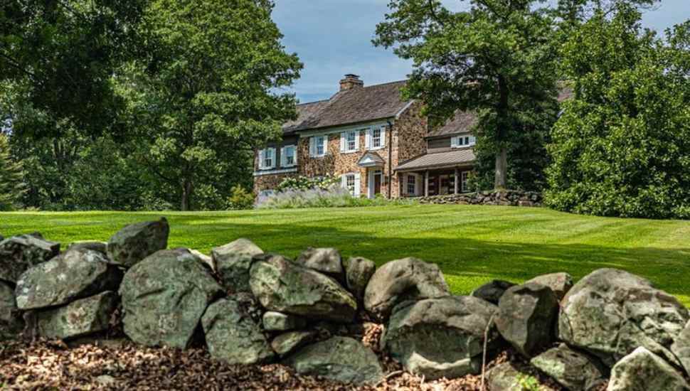 house behind rock wall