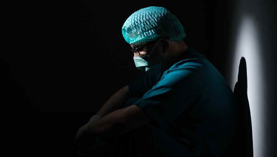 man in scrubs in the dark