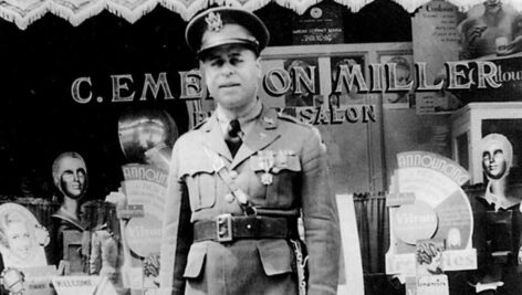 man in uniform in front of store