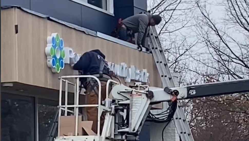 men hanging sign