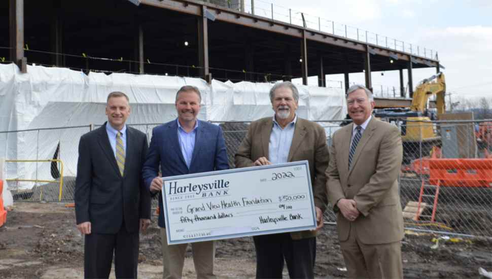 men holding large check