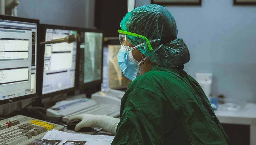 woman in scrubs at monitors