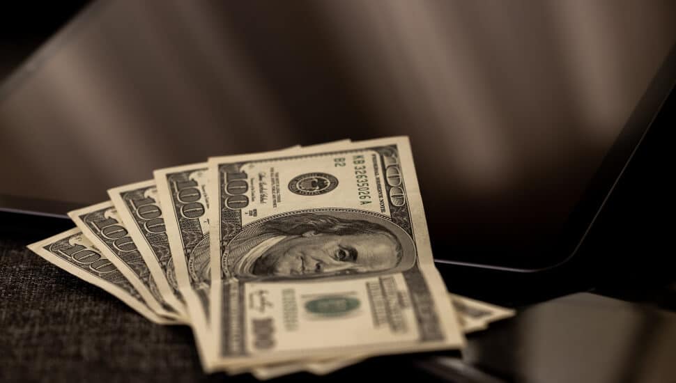 $500 Bills laid out on a laptop