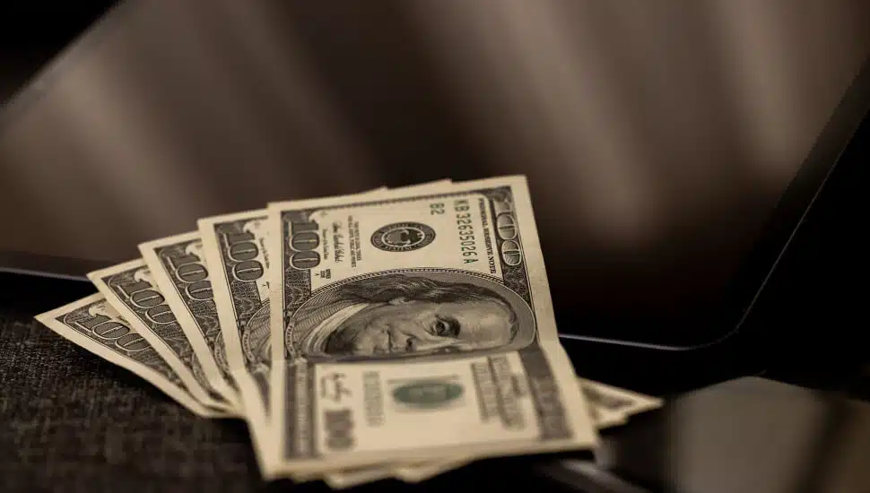 $500 Bills laid out on a laptop