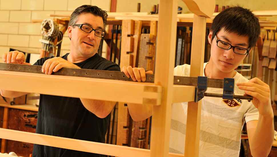 man helping student