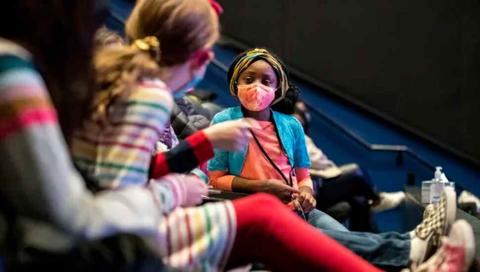 masked girl in a theater