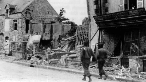 men walking a bombed street