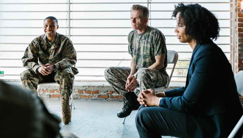 military men sitting with woman