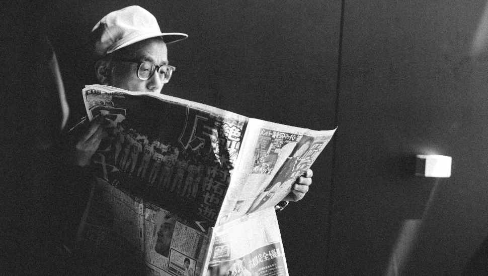 man with hat and paper