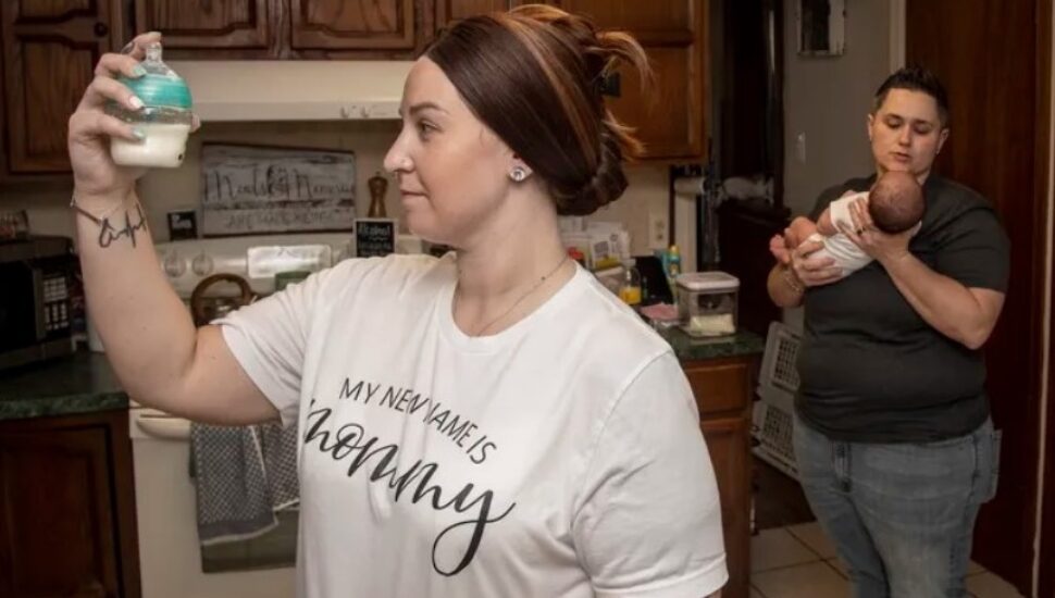 Ashley Brown (front) and Kristen Bradwell prepare infant formula for their month-old daughter, Amelia, in their home in Brookhaven.