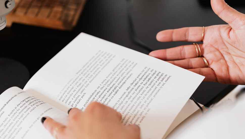 book with hands