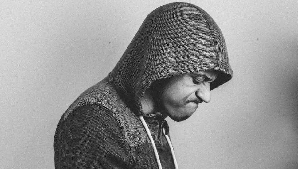scowling man in hoodie