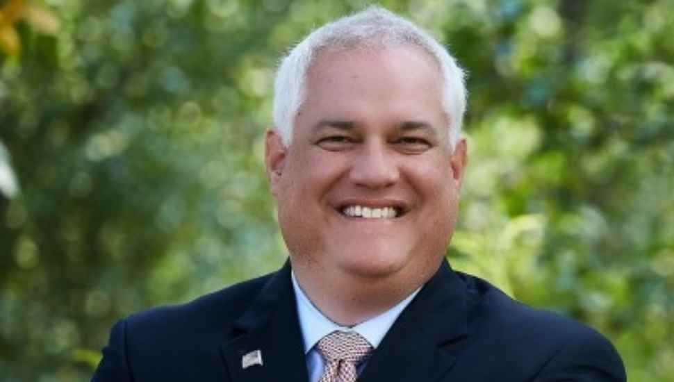 smiling man with white hair