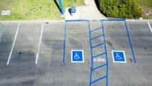 aerial view of two disabled parking spots in an empty parking lot.