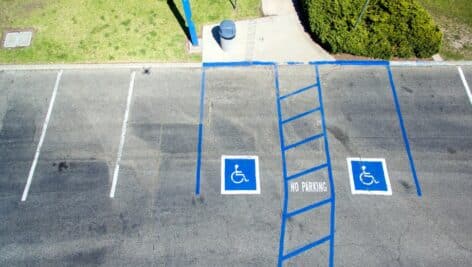 aerial view of two disabled parking spots in an empty parking lot.