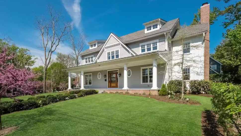 home with pillars on a big lawn