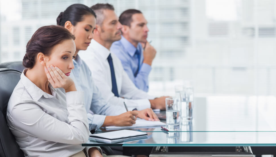 A woman suffers through a boring meeting