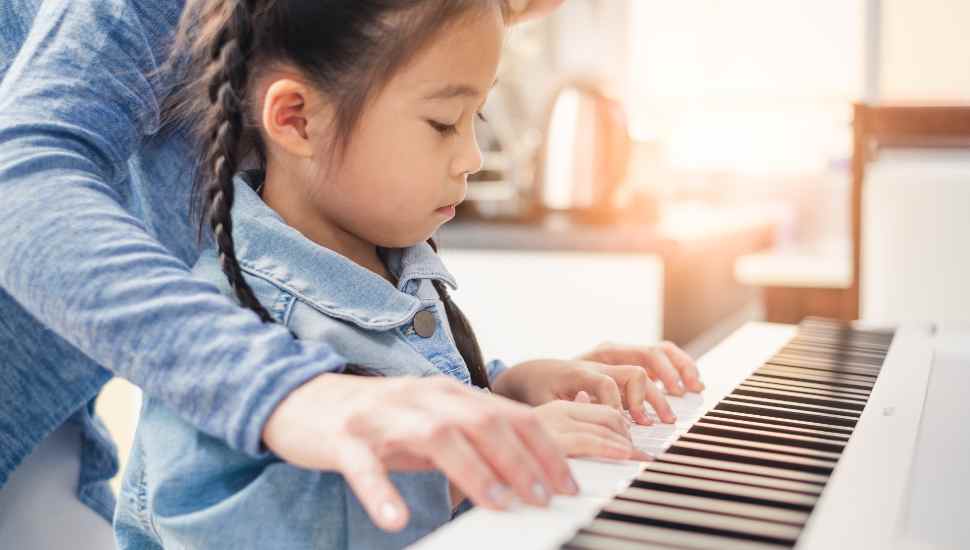 girl and adult at piano