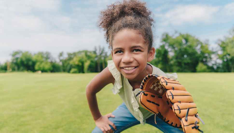 child playing baseball in park