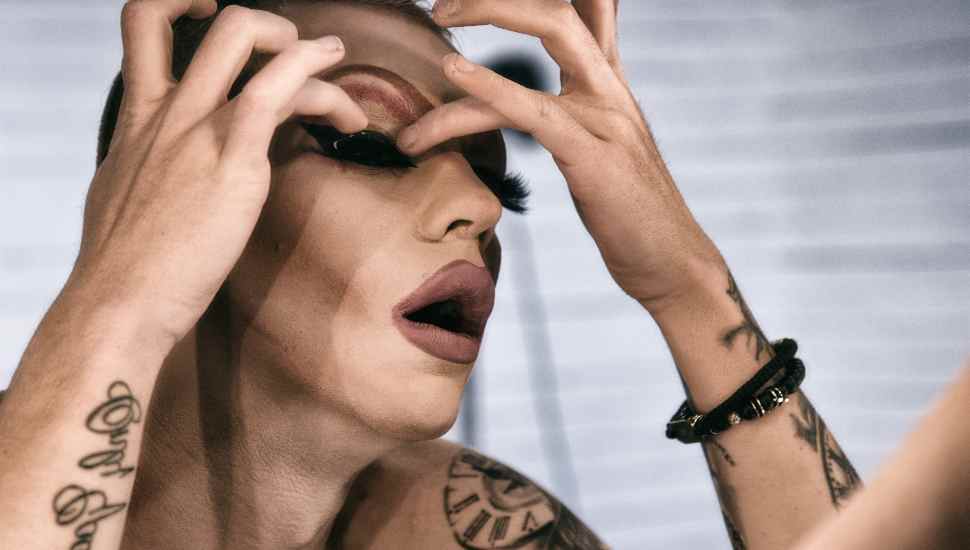 man putting on eyelashes